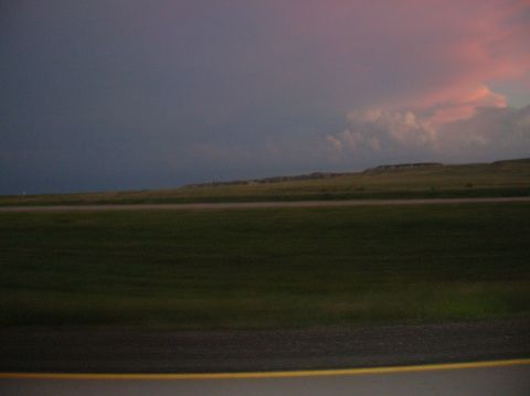 1996 Ford Bronco - A landscape shot captures rolling hills and fields under a dramatic twilight sky.