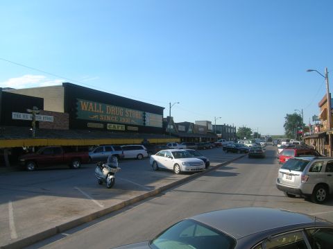1996 Ford Bronco - A street scene in Wall Drug Store, with various vehicles parked along the road and sidewalk.
