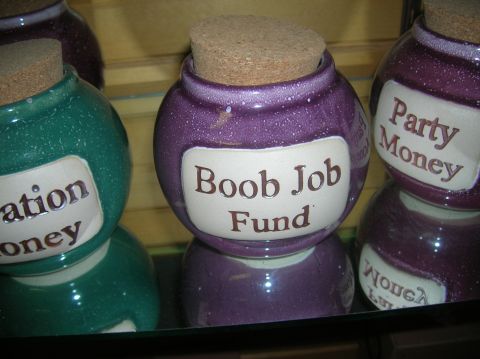 1996 Ford Bronco - Decorative jars with humorous labels for saving money are displayed on a reflective surface.