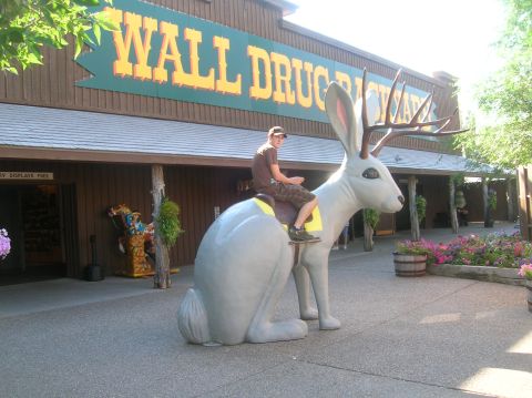 1996 Ford Bronco - A man rides a jackalope statue outside the Wall Drug Store.