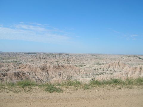 1996 Ford Bronco - A vast expanse of eroded hills and valleys stretches under a clear blue sky.
