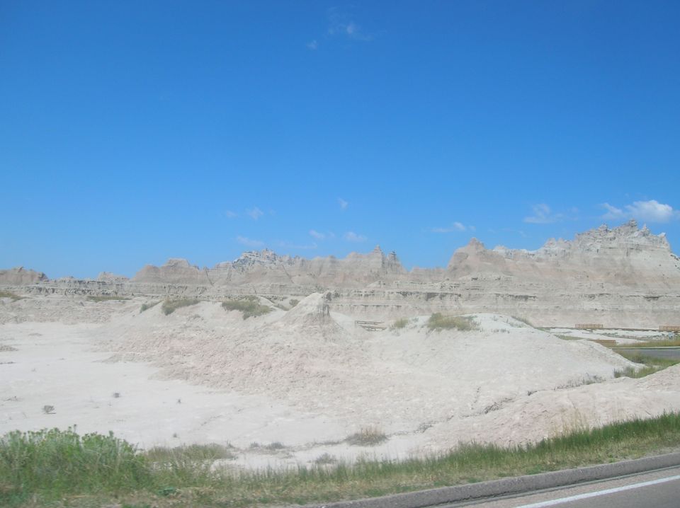 Badlands National Park with eroded rock formations under a clear blue sky