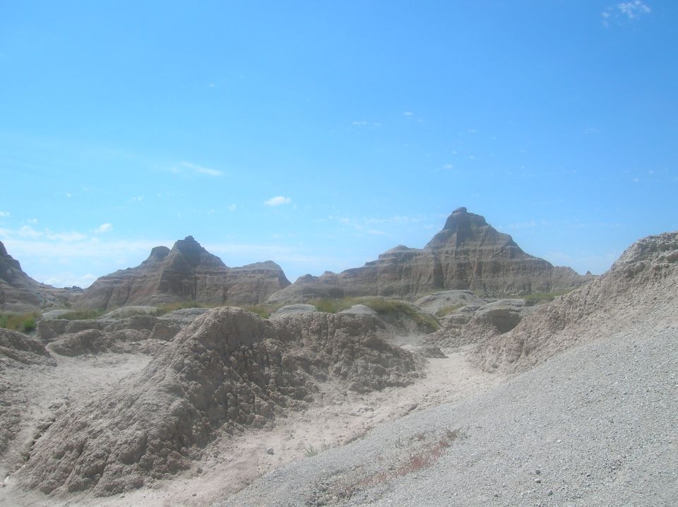 Badlands formations under a clear blue sky
