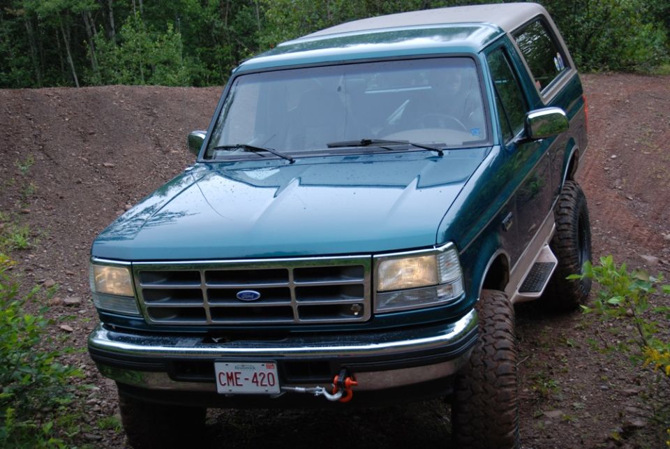 Green 1996 Ford Bronco on dirt road, front view. License plate CME-420