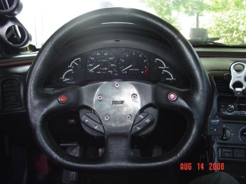 1993 Ford Probe - Interior view of a 1993 Ford Probe, an aftermarket steering wheel and custom gauge cluster.