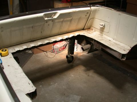 1964 Ford Ranchero - The bed of a 1964 Ford Ranchero is shown with its frame exposed and some wiring visible.