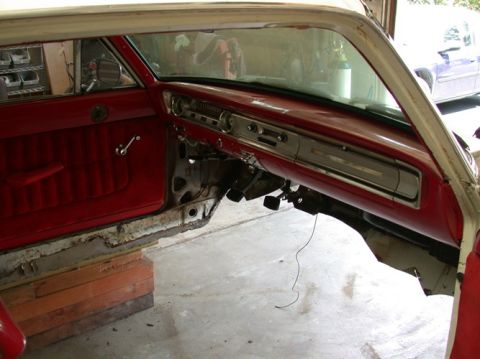 1964 Ford Ranchero - Interior view of a 1964 Ford Ranchero during restoration, showing red upholstery and dashboard components.