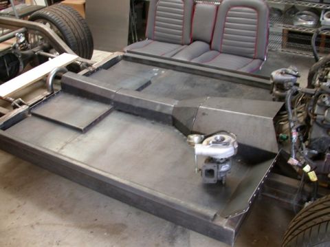 1964 Ford Ranchero - Custom car chassis build bucket seats and a turbocharger, likely for a project car.