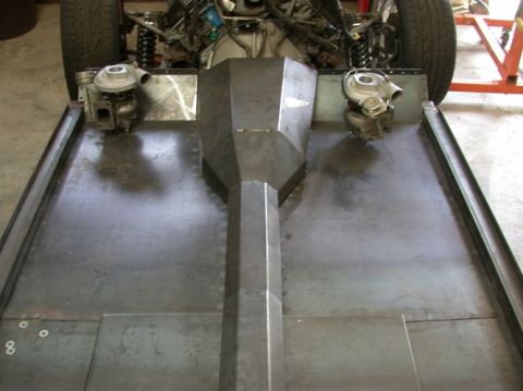 1964 Ford Ranchero - The underside of a vehicle chassis is shown, equipped with twin turbochargers and a central exhaust tunnel.