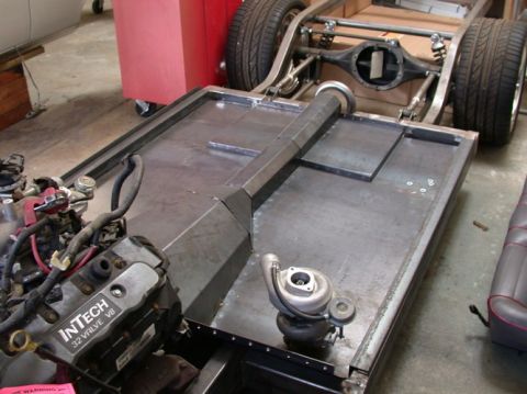1964 Ford Ranchero - Custom vehicle chassis assembly an InTech 32 valve V8 engine and a turbocharger, undergoing construction.