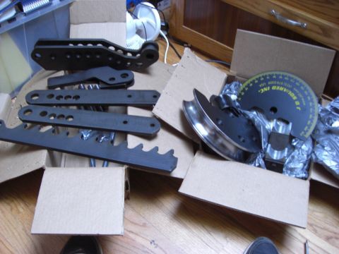 1993 Ford Bronco - Metal parts and a pipe bender die kit are laid out on the floor.