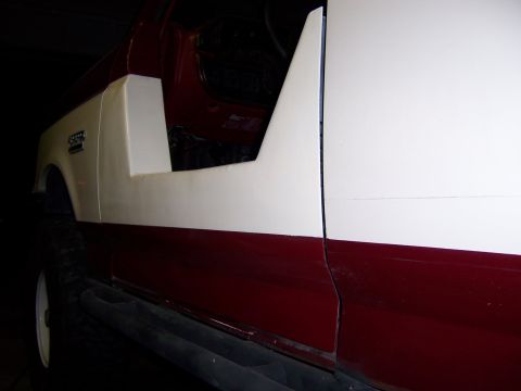 1991 Ford Bronco - The side panel of a Suzuki Samurai shows a two-tone paint scheme with the door removed.