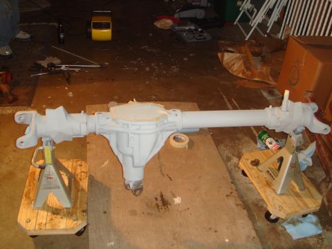 1992 Ford Bronco - A differential axle assembly is shown on jack stands in a workshop setting.