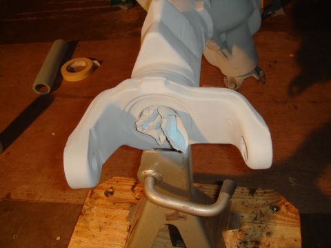 1992 Ford Bronco - An automotive part is prepped on a jack stand, with tape and a roller visible in the background.