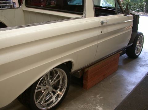1964 Ford Ranchero - A white 1964 Ford Ranchero is shown from the side, custom wheels and a pickup bed.