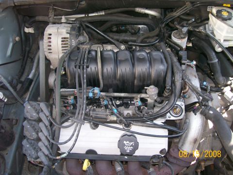 1995 Mercury Grand Marquis - Close-up view of a vehicle's engine compartment, showing various components and wiring.