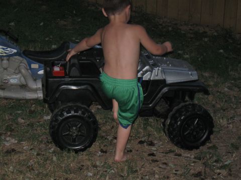 1994 Ford Bronco - A child plays with a toy jeep in the grass.