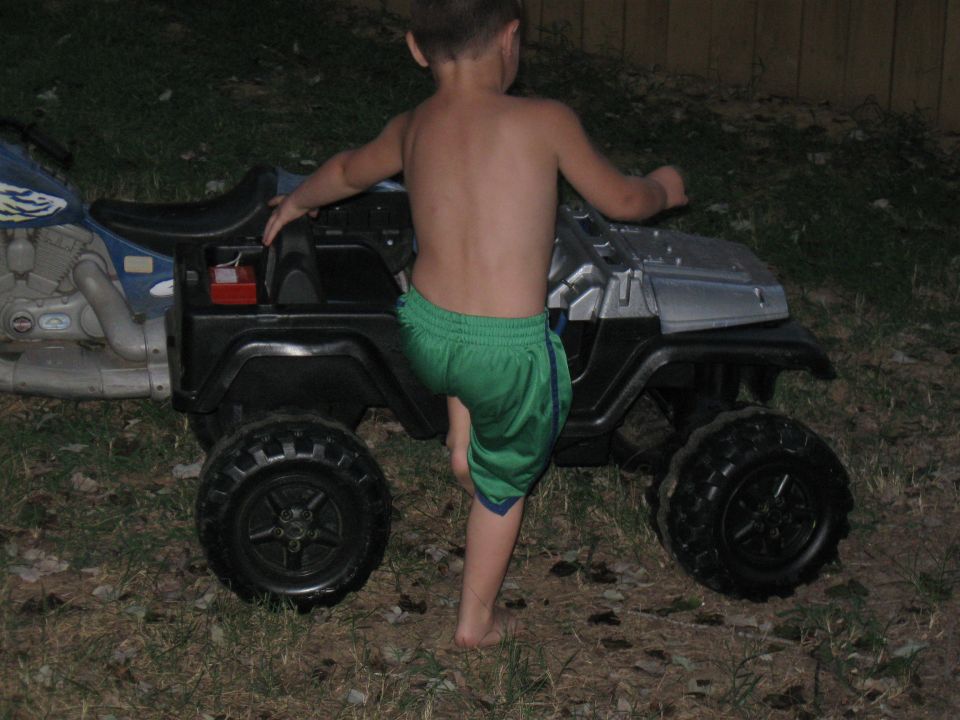 Toy jeep with large tires, seen from the side