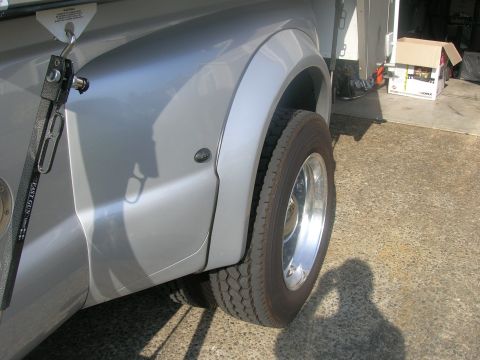 2008 Ford F-450 - Close-up view of the rear fender and dual wheels of a silver 2008 Ford F-450 truck.