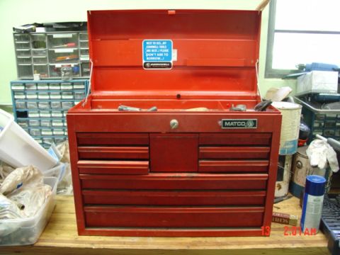 1985 Ford Bronco - A red Matco toolbox sits on a wooden surface, with various drawers open and tools visible inside.