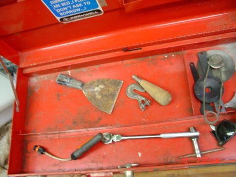 1985 Ford Bronco - A collection of assorted tools are organized inside an open red toolbox.