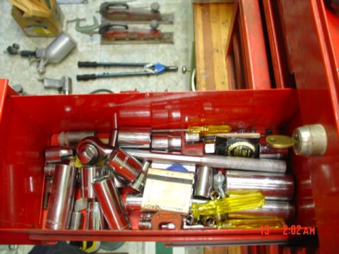 1985 Ford Bronco - A variety of tools are organized within a red toolbox drawer, including sockets, ratchets, and screwdrivers.