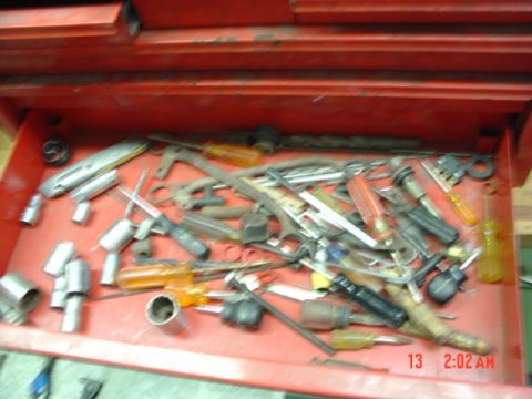 1985 Ford Bronco - A red toolbox drawer contains a variety of hand tools, including screwdrivers and sockets.