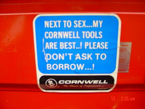 1985 Ford Bronco - A sticker with a humorous message about Cornwell tools is affixed to a red background.