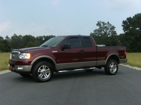 2005 Ford F-150 - This maroon 2005 Ford F-150 pickup truck is shown from a 3/4 front angle.