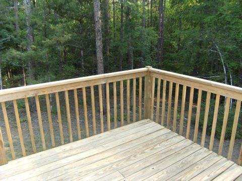 1992 Ford F-150 - A wooden deck and railing are shown with a forest in the background. The Supermotors.net logo is visible in the lower right corner.