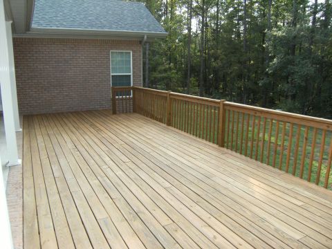 1992 Ford F-150 - Newly built pressure-treated wood deck with a picket railing attached to a brick house, looking out over a grassy yard and dense pine woods…