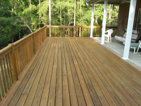 1992 Ford F-150 - A wooden deck and covered porch area are shown with surrounding trees and outdoor furniture.