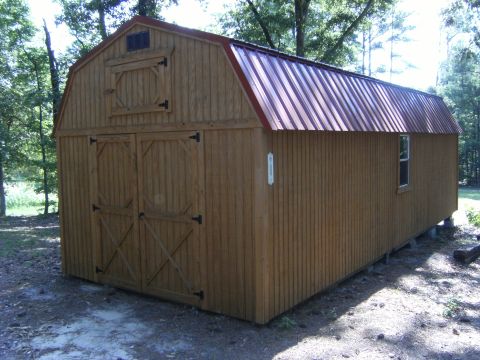 1992 Ford F-150 - A wooden barn-style storage shed with a red metal roof sits on concrete blocks in a yard.