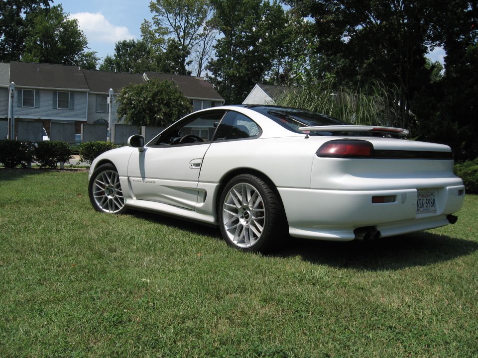 White Dodge Stealth coupe rear three-quarter view parked on grass
