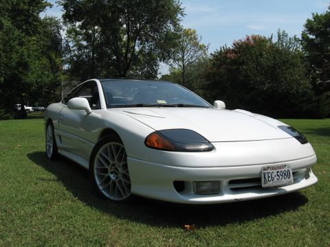 1992 Dodge Stealth - A white 1992 Dodge Stealth sports car is shown from a three-quarter front view, parked outdoors on a grassy lawn.