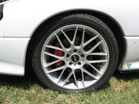 1992 Dodge Stealth - Close-up of a car's front wheel and tire, showing aftermarket modifications.