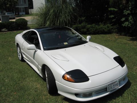 1992 Dodge Stealth - White 1992 Dodge Stealth with a black roof and black headlight covers sits on a grassy lawn.