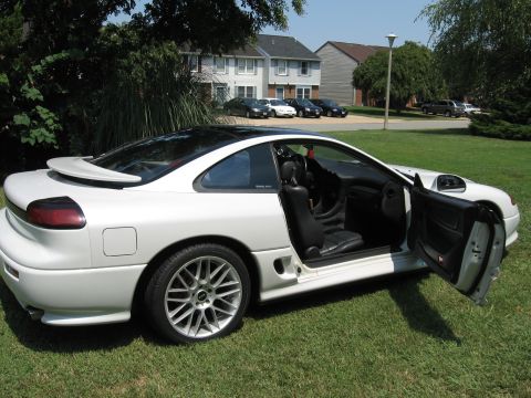 1992 Dodge Stealth - A white 1992 Dodge Stealth is parked on a grassy lawn with its doors open, showing the interior.
