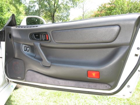 1992 Dodge Stealth - Interior view of a car door panel, showing the handle, window controls, and speaker grille.