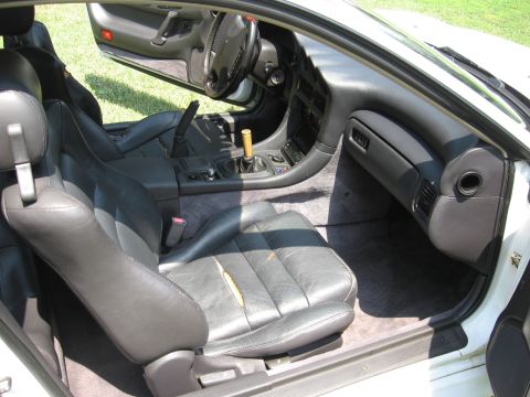 1992 Dodge Stealth - Interior view of a 1992 Dodge Stealth, highlighting the driver's seat and dashboard with the passenger door open.