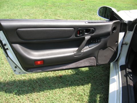 1992 Dodge Stealth - Interior view of a car's driver side door panel, revealing black trim and controls.