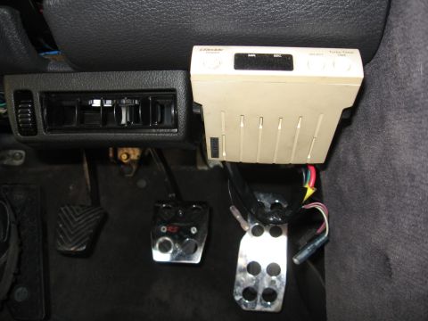 1992 Dodge Stealth - Close-up of car pedals and an aftermarket climate control unit mounted on the dashboard.