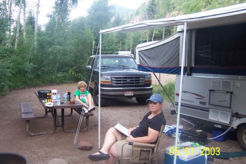 1996 Ford Bronco - A family enjoys a camping trip with their Ford Bronco and pop-up trailer.