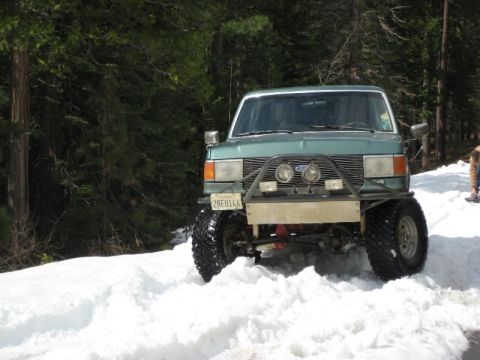 1991 Ford Bronco - This 1991 Ford Bronco is equipped for off-road conditions and is seen navigating a snowy path.