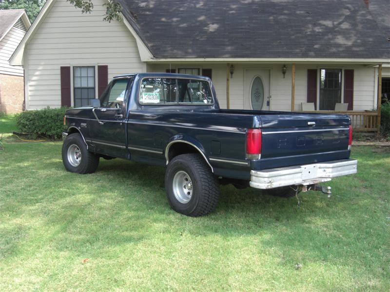 Dark blue 1989 Ford F-150 pickup truck, rear 3/4 view
