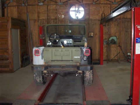 1978 Jeep CJ5 - This Jeep CJ is parked on a lift in a workshop, showing its rear end and interior.