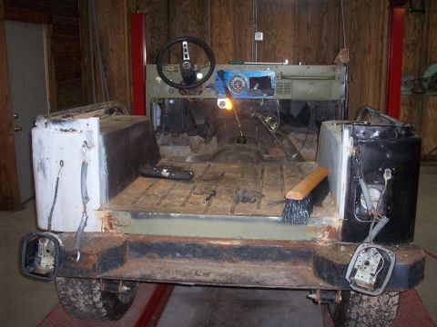1978 Jeep CJ5 - The interior and rear of a 1978 Jeep CJ5, showing the floor, dashboard, and steering wheel, appears to be undergoing restoration.