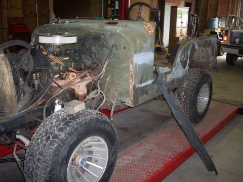 1978 Jeep CJ5 - This 1978 Jeep CJ5 is shown with its engine compartment open and body panels removed, revealing its construction.