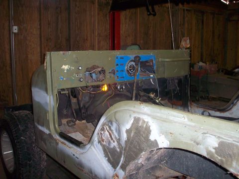 1978 Jeep CJ5 - The interior of a Jeep CJ shows exposed wiring and a partially prepped body during a restoration project.