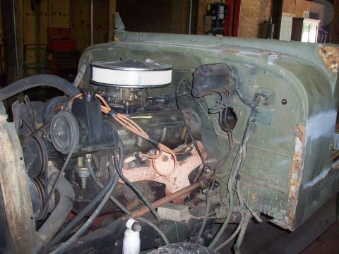 1978 Jeep CJ5 - The engine bay of a vehicle is shown, with the V8 engine and associated components visible.